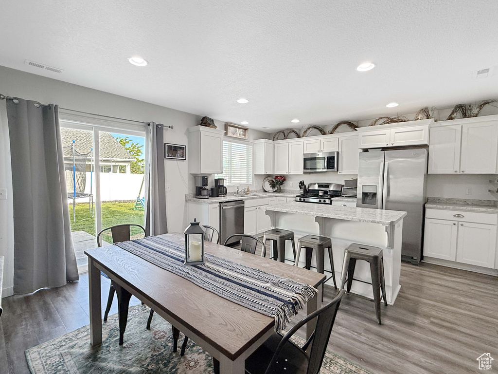 Dining space featuring light wood-style flooring and recessed lighting