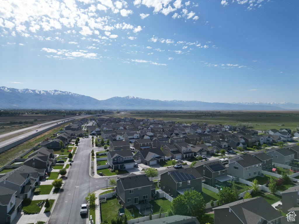 Aerial perspective of suburban area featuring a mountain backdrop