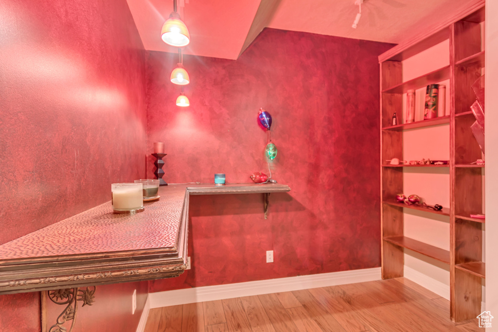 Bathroom with wood finished floors and baseboards