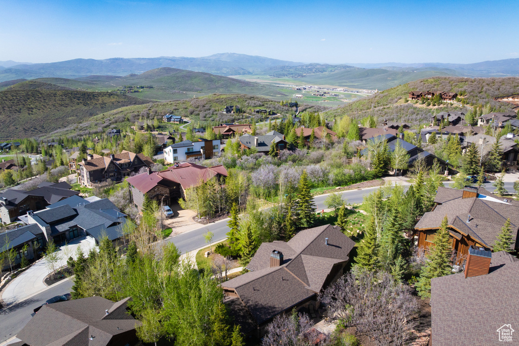 Aerial view of property's location with nearby suburban area and a mountain backdrop
