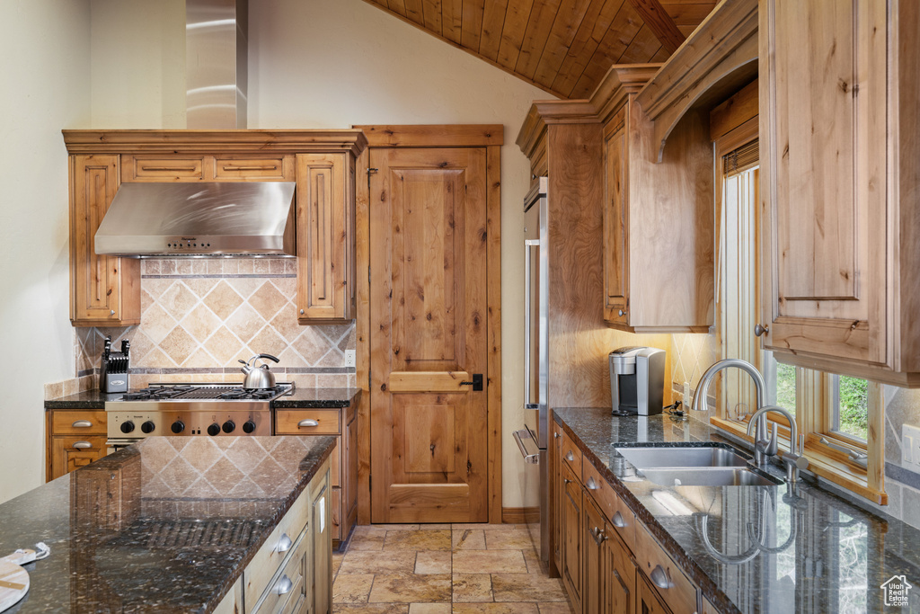 Kitchen featuring under cabinet range hood, a sink, backsplash, wood ceiling, and brown cabinetry