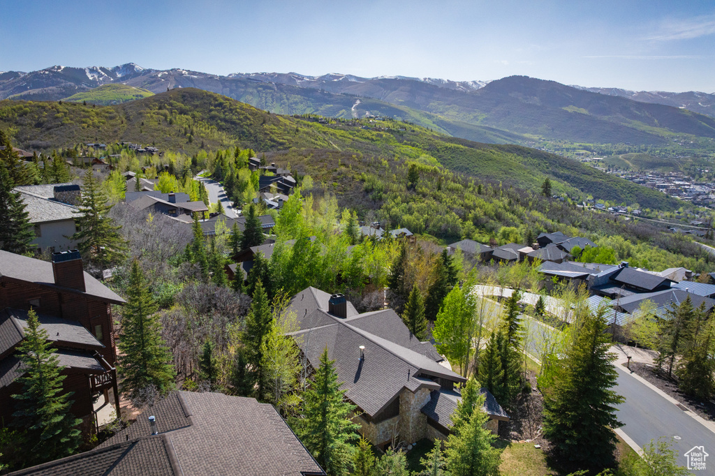 Aerial overview of property's location featuring a mountainous background and nearby suburban area