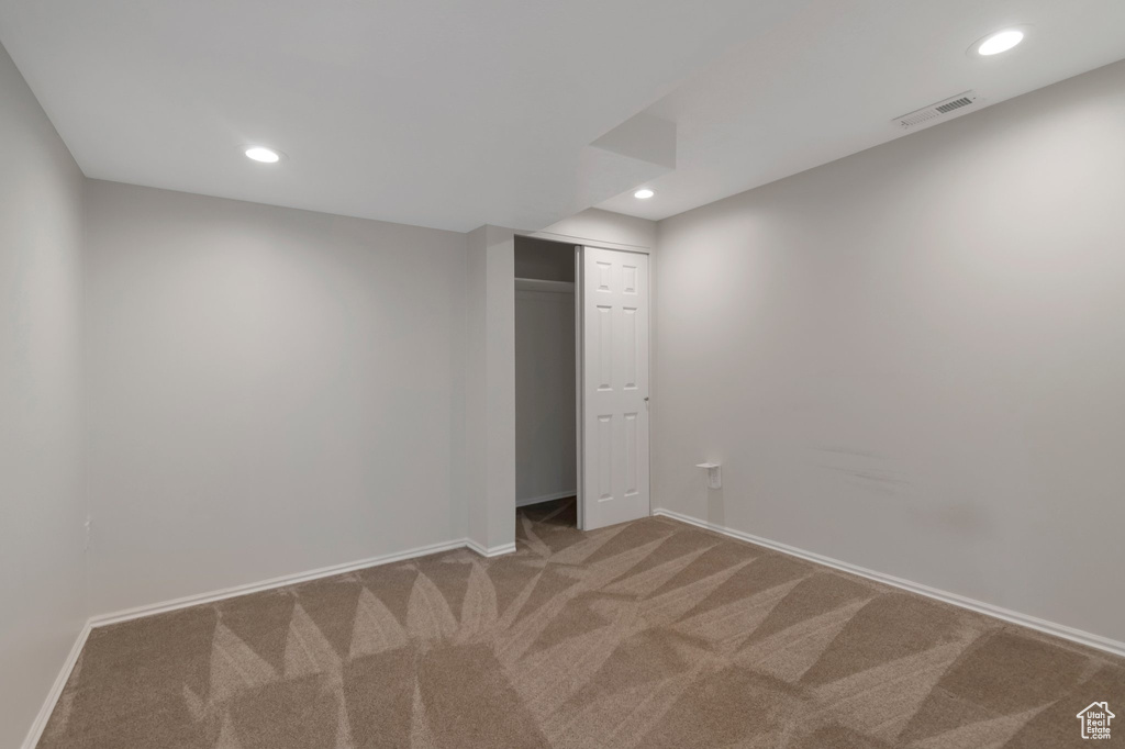 Finished basement with carpet flooring, baseboards, and recessed lighting