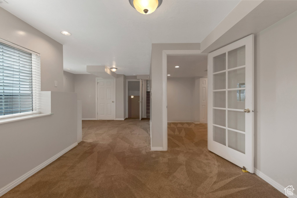 Corridor featuring carpet floors, baseboards, recessed lighting, and french doors