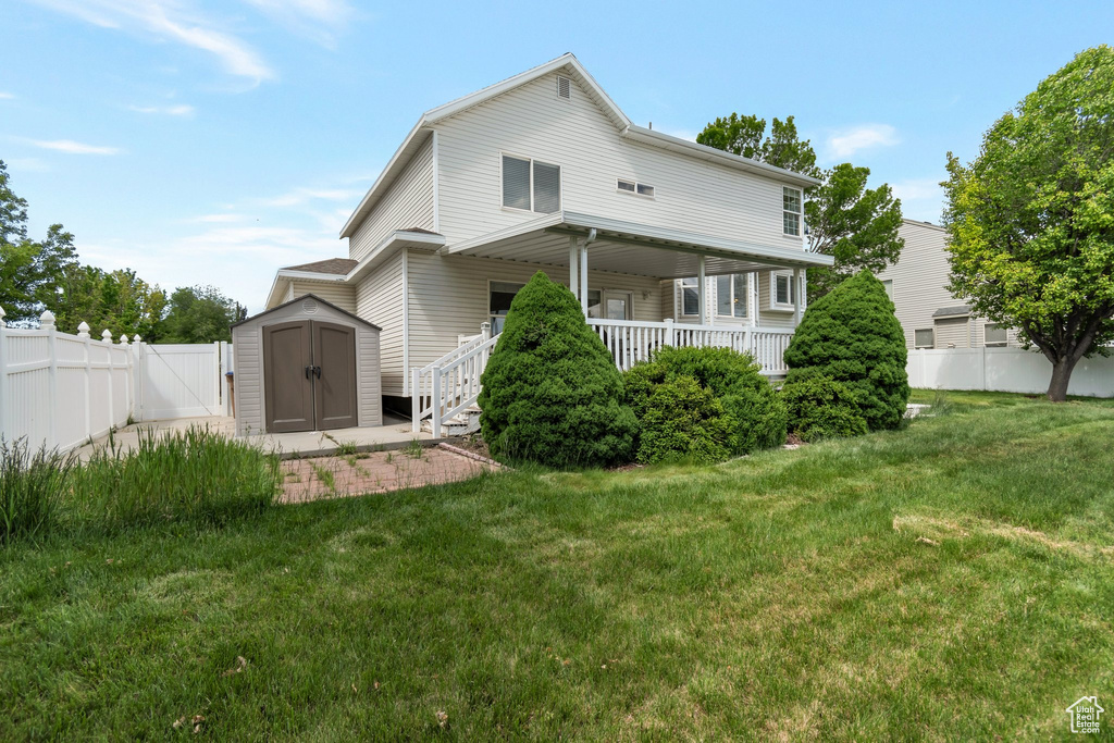 Rear view of property featuring covered porch