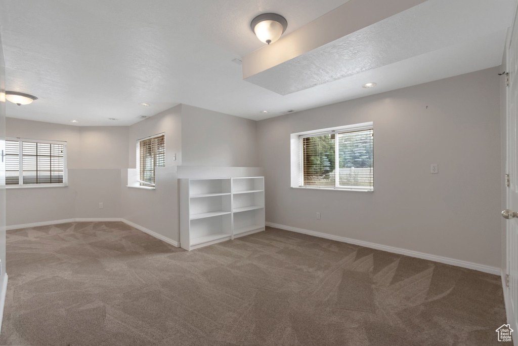 Unfurnished room featuring carpet floors, baseboards, and recessed lighting