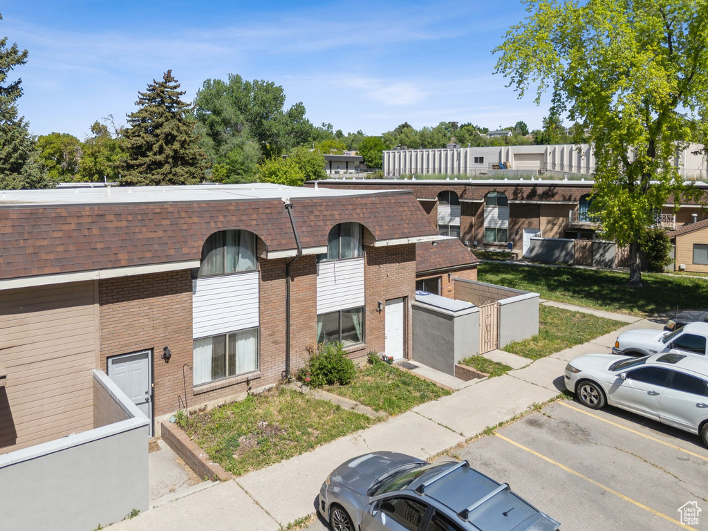 View of property with uncovered parking