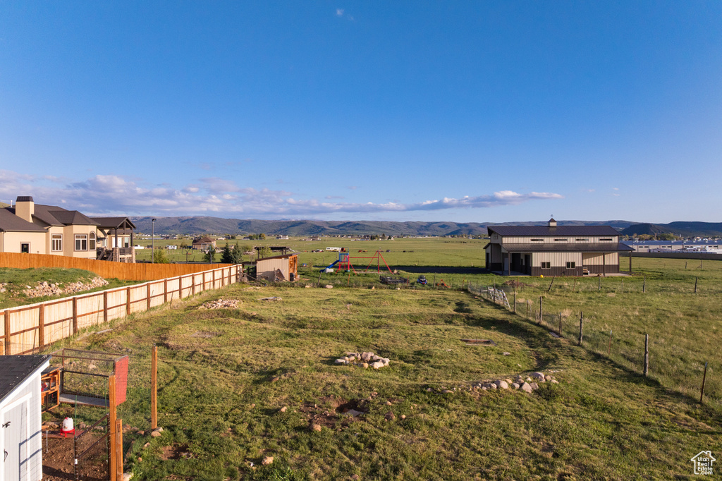 View of yard with a view of rural / pastoral area and a mountain view