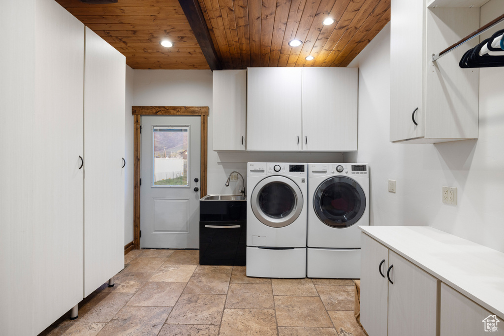 Laundry area featuring wood ceiling, cabinet space, washer and clothes dryer, recessed lighting, and stone tile flooring