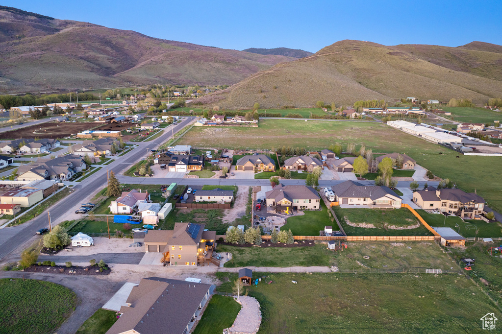 Aerial overview of property\'s location featuring nearby suburban area and a mountainous background