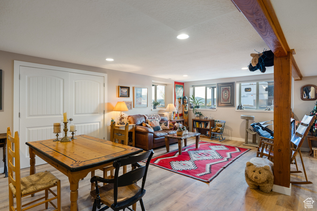 Dining area with light wood-style floors, recessed lighting, and baseboards