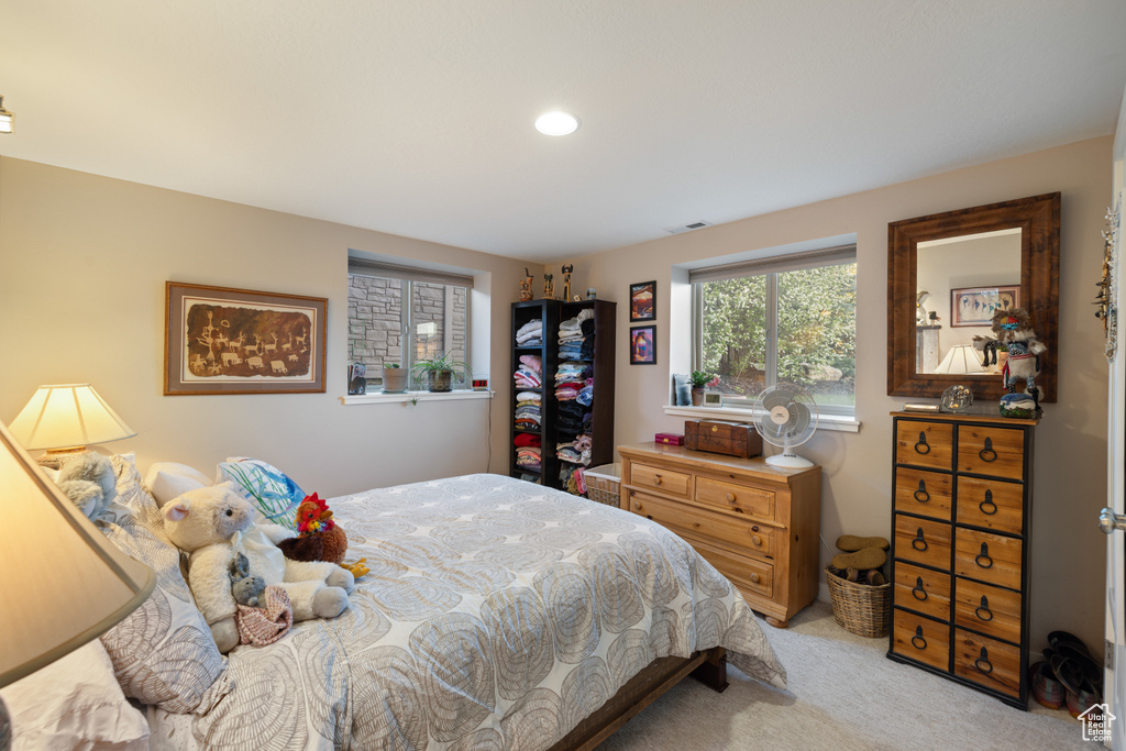 Bedroom with light carpet and recessed lighting