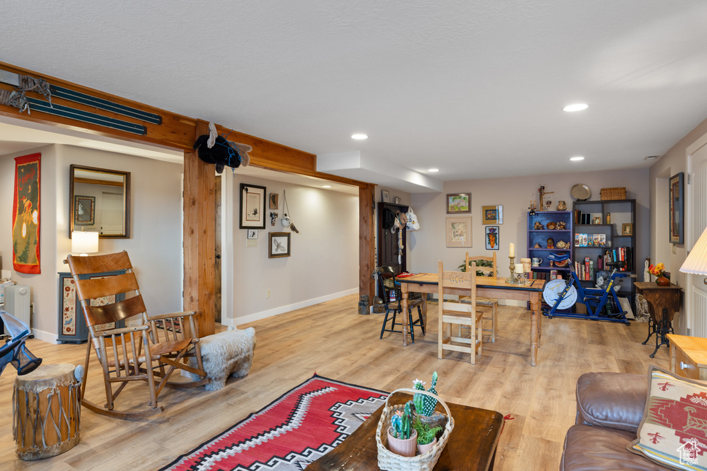 Living room with wood finished floors, recessed lighting, and baseboards