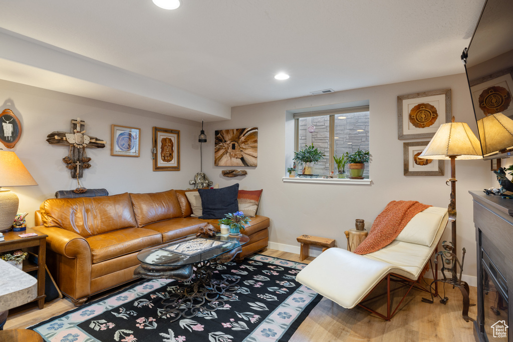 Living room featuring wood finished floors, baseboards, and recessed lighting