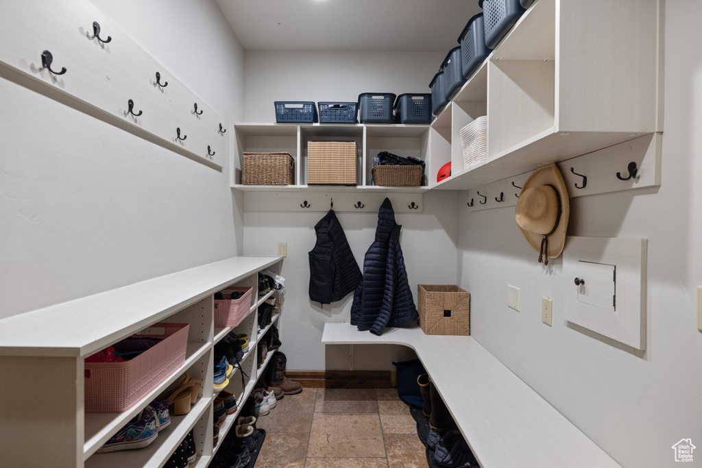 Mudroom featuring baseboards and stone finish flooring