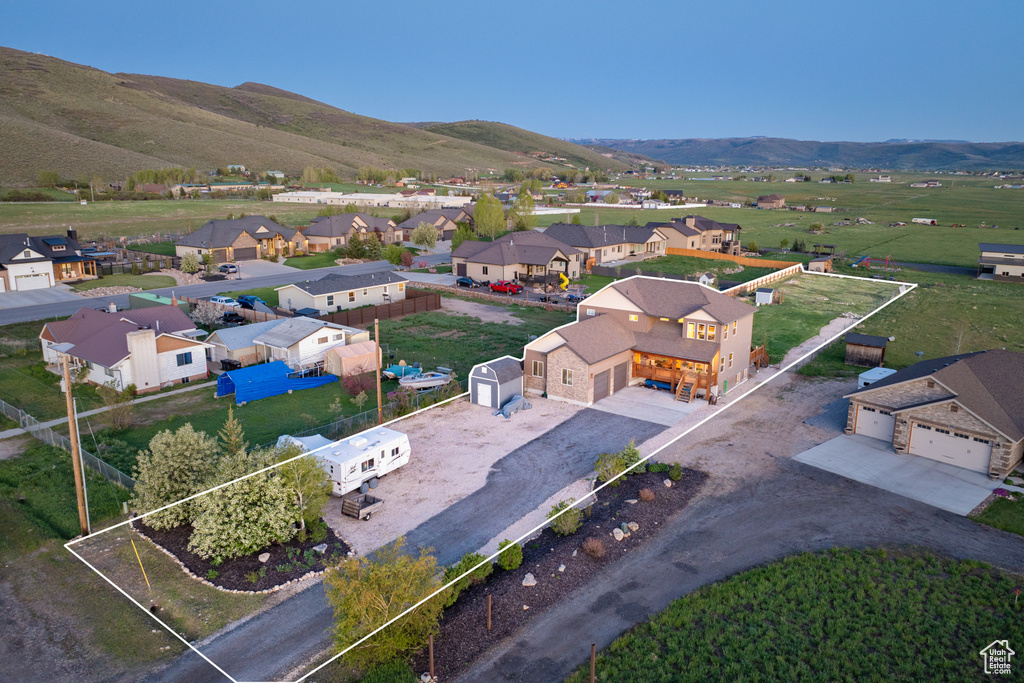 Aerial perspective of suburban area featuring mountains and property boundaries highlighted