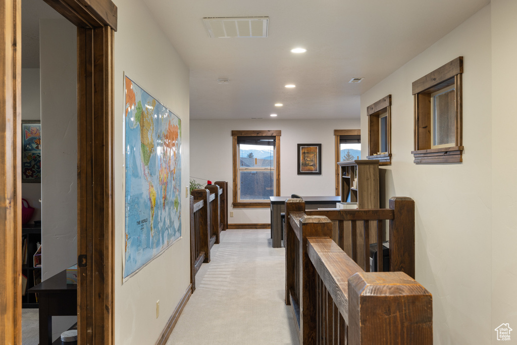 Hallway featuring recessed lighting, baseboards, and light colored carpet