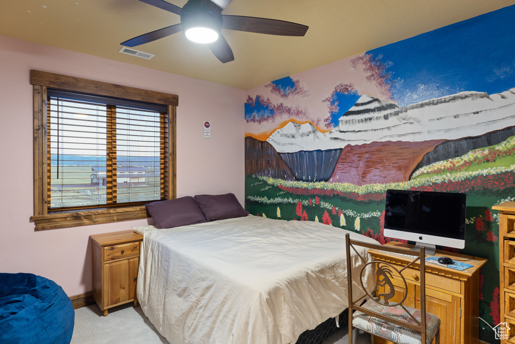 Bedroom with light carpet, baseboards, and ceiling fan