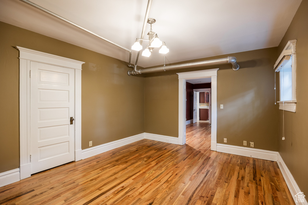 Unfurnished room featuring wood finished floors and baseboards