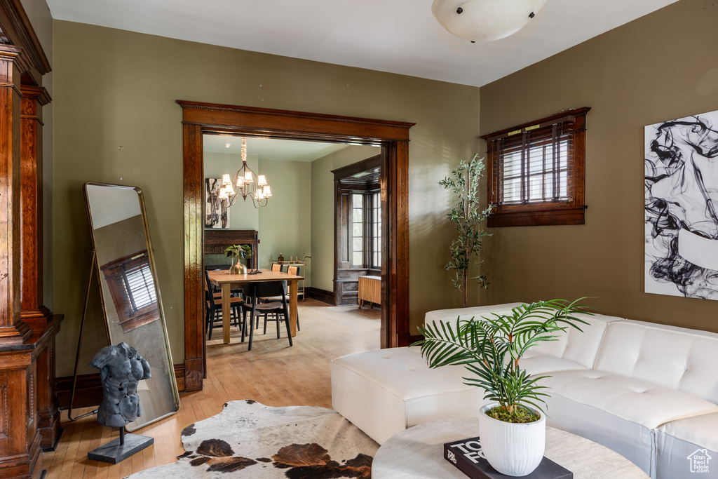 Living area featuring a chandelier and light wood-style floors