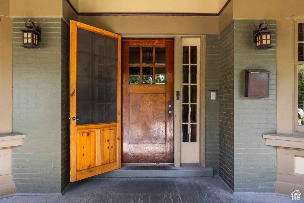 Property entrance featuring brick siding