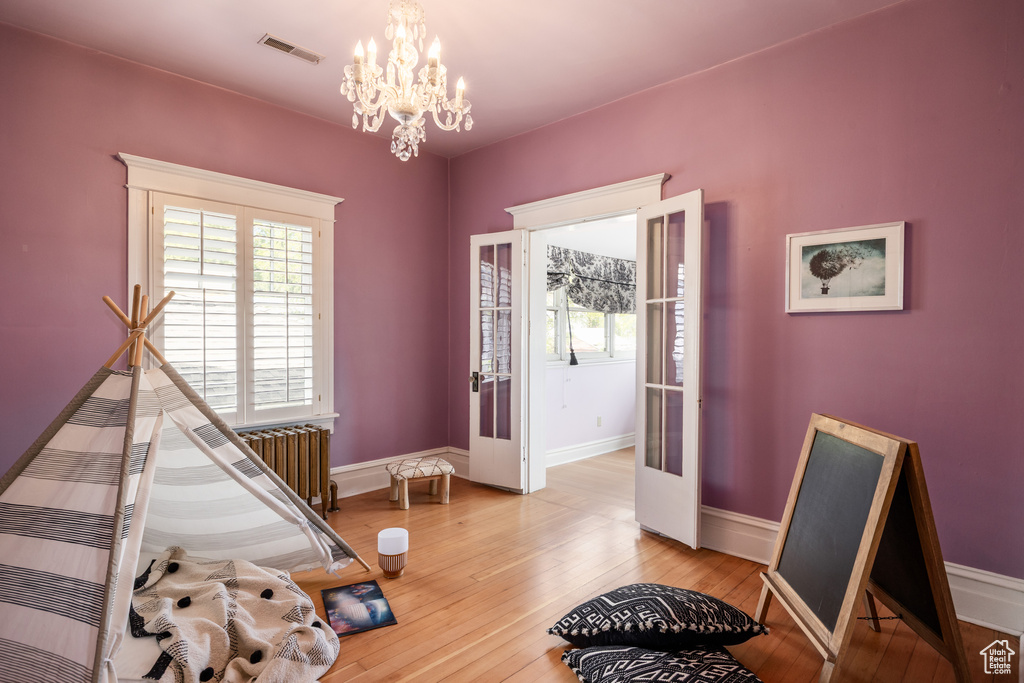 Game room featuring plenty of natural light, a chandelier, and baseboards
