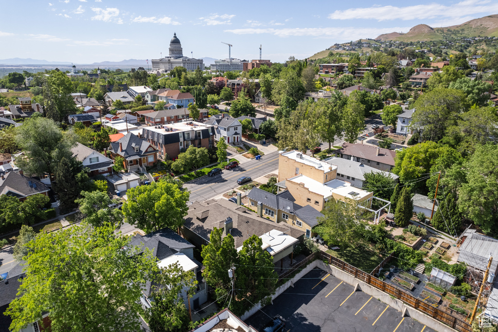 Aerial view of property\'s location featuring a mountain backdrop and nearby suburban area