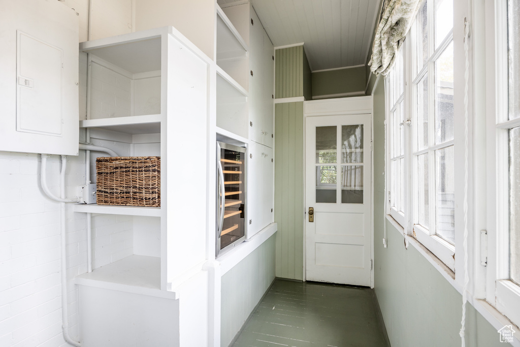 Walk in closet with electric panel and beverage cooler