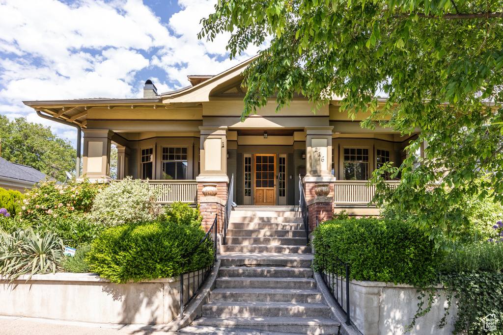 View of front of house featuring a porch and stairway