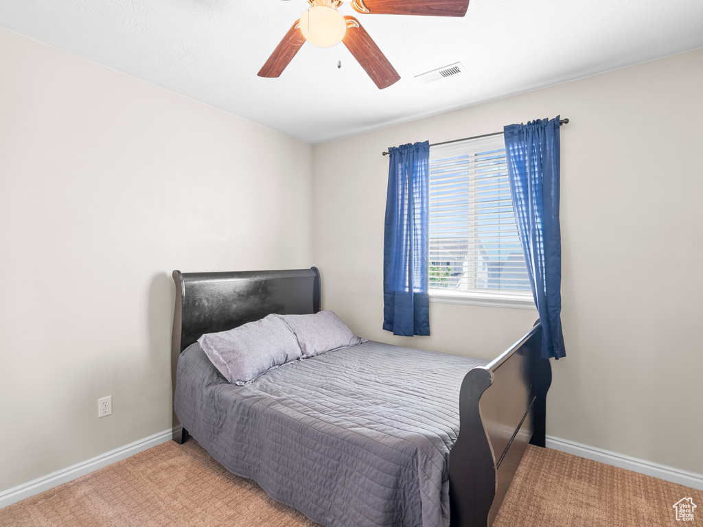 Bedroom featuring carpet flooring, baseboards, and a ceiling fan