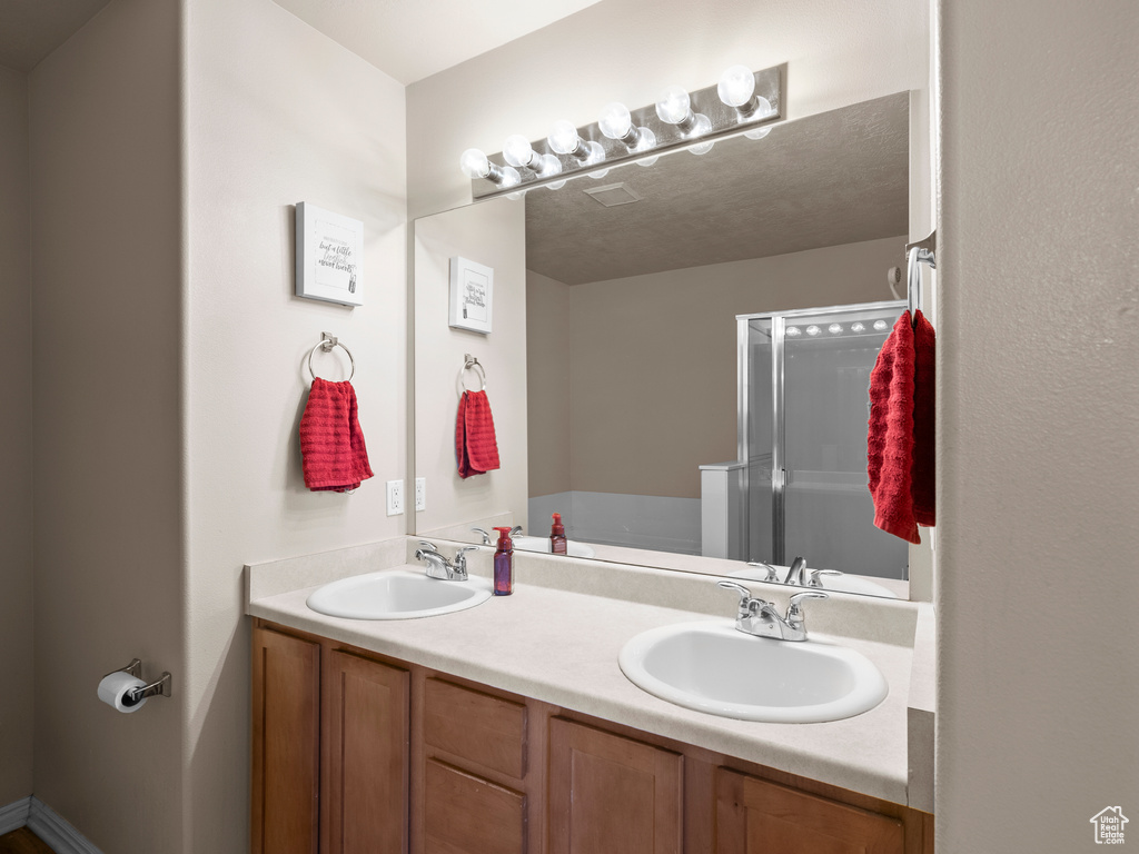 Full bathroom with double vanity and a bath