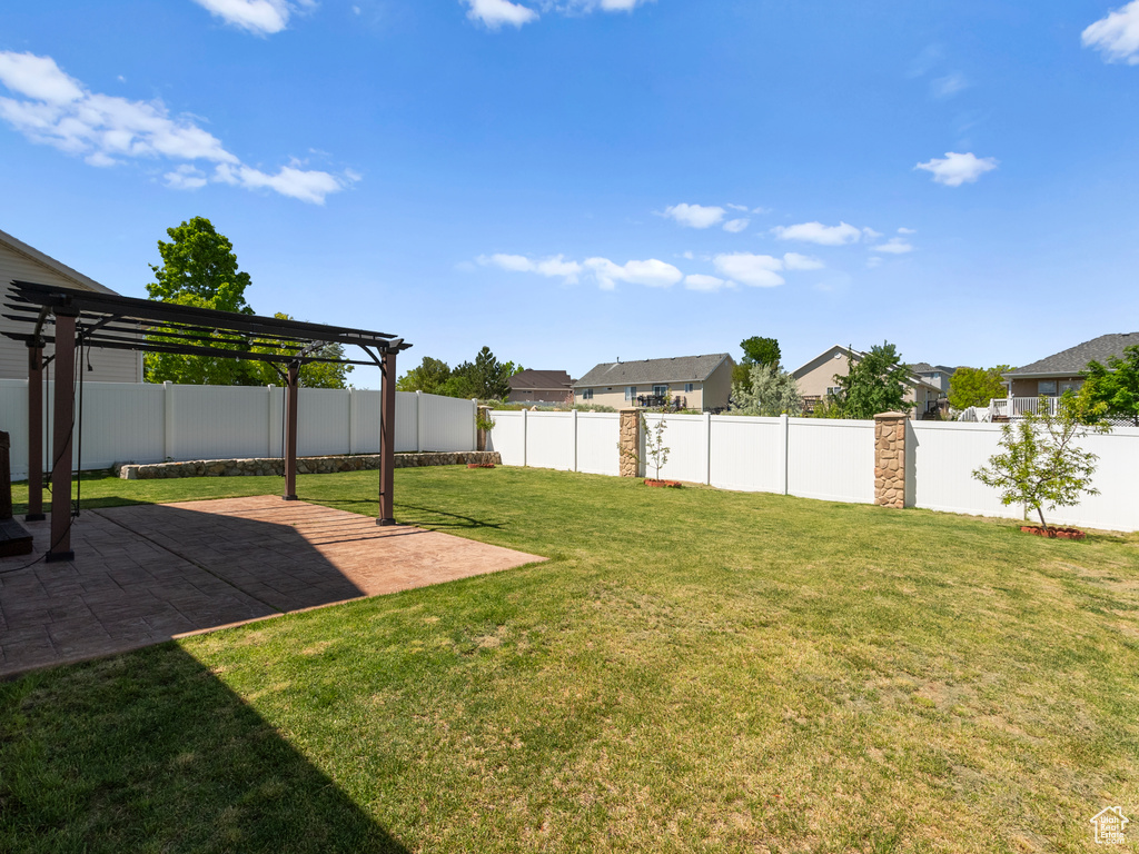View of yard with a pergola, a patio area, and a residential view