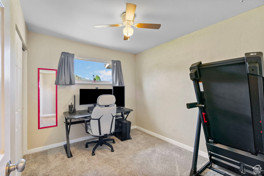 Office area featuring a ceiling fan, carpet floors, and baseboards