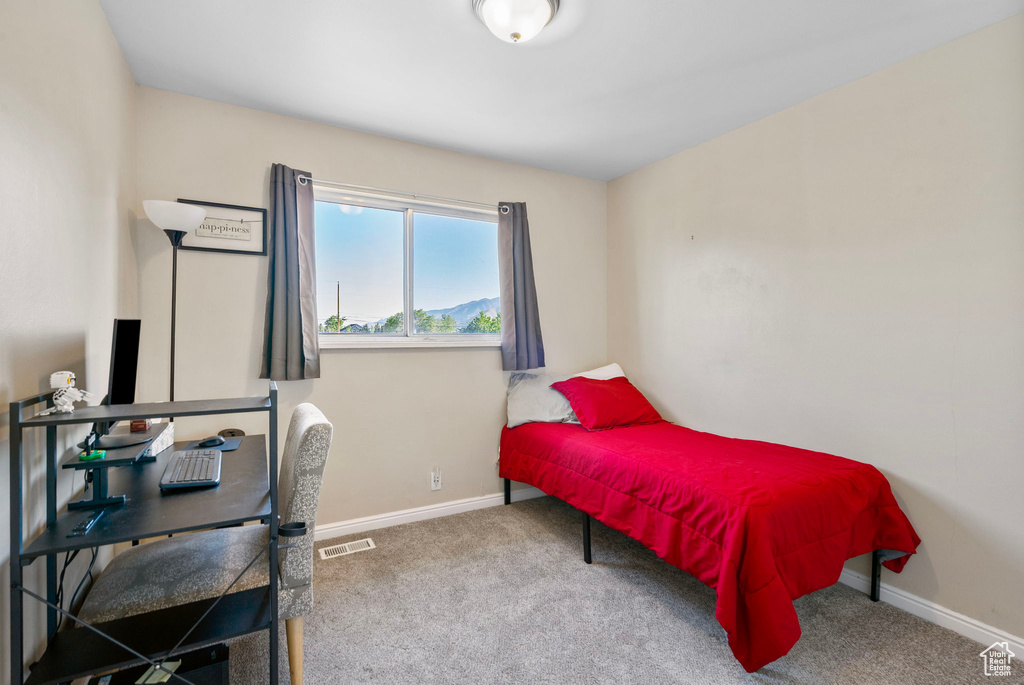 Carpeted bedroom featuring baseboards