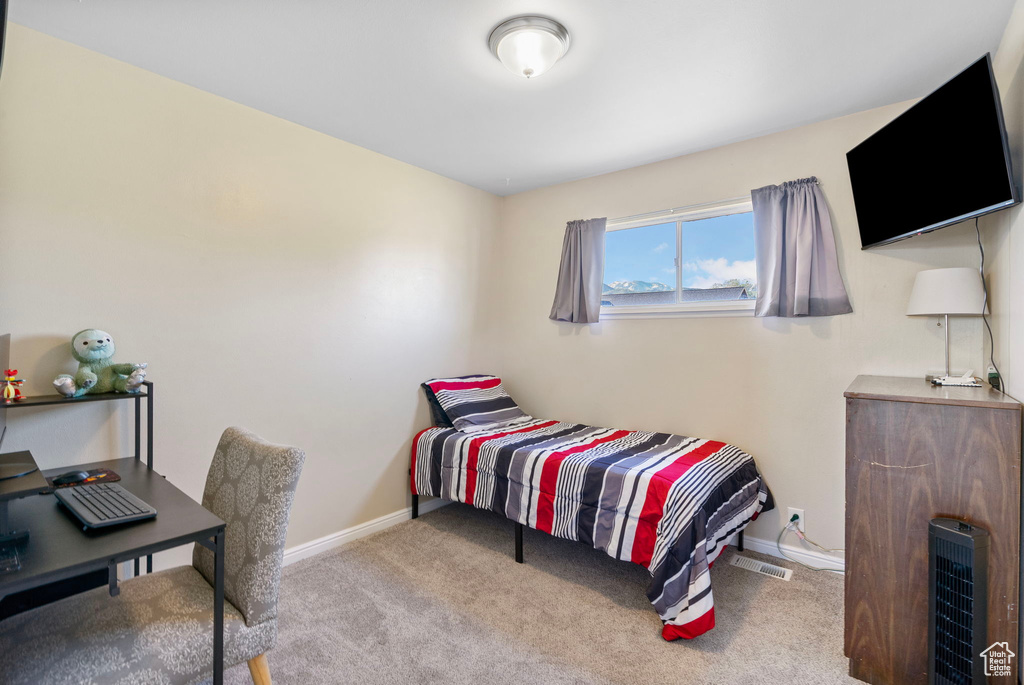 Bedroom featuring carpet and baseboards