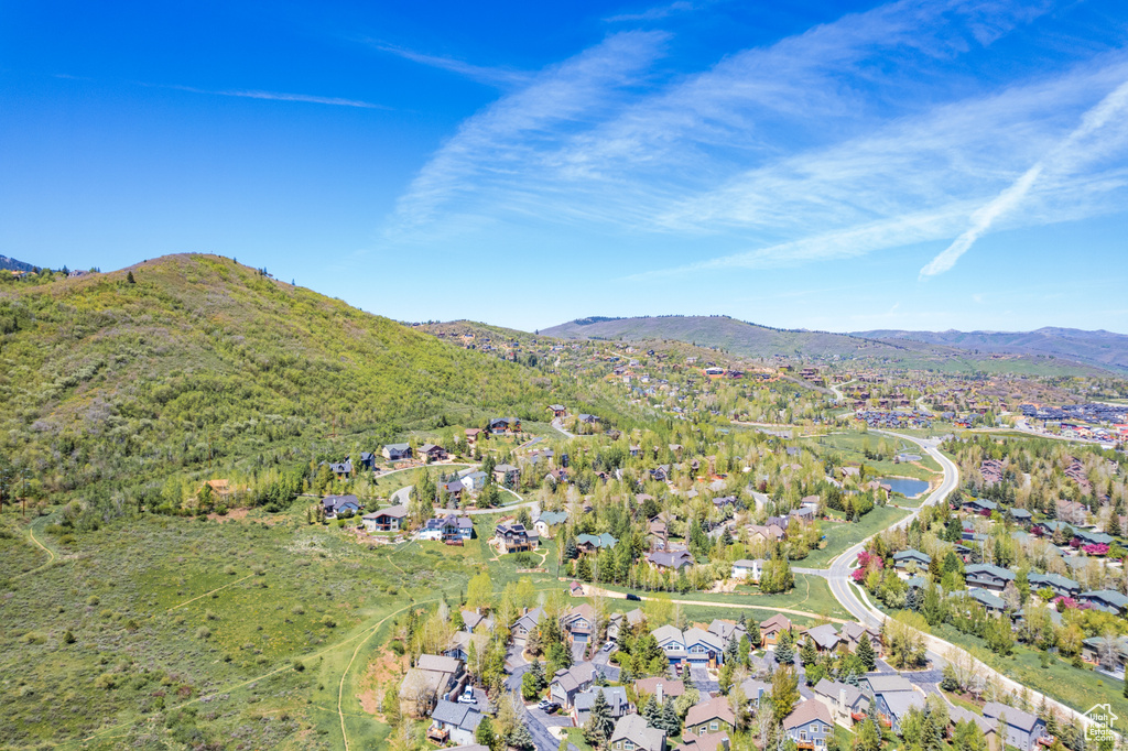 Aerial overview of property's location with nearby suburban area and a mountainous background