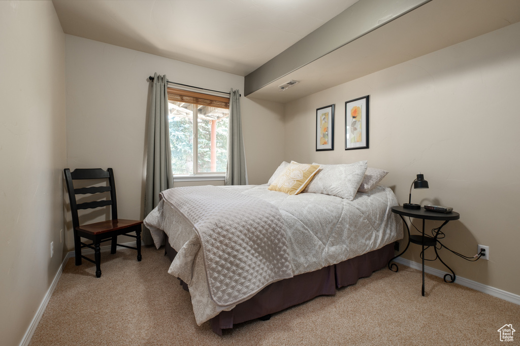 Bedroom featuring carpet and baseboards