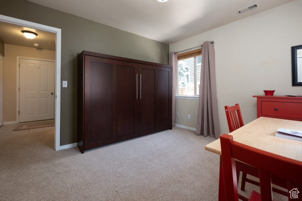 Bedroom featuring light colored carpet and baseboards