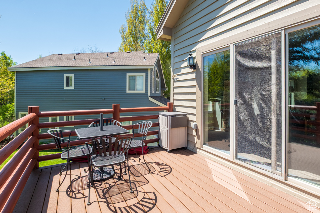 Wooden terrace featuring outdoor dining area