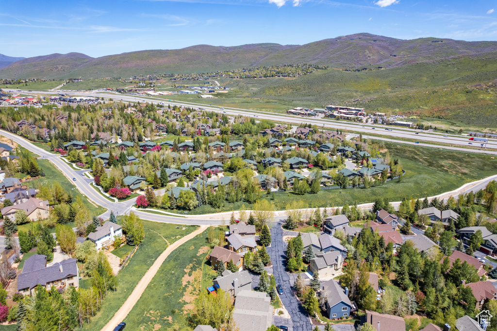 View of property location featuring nearby suburban area and a mountain backdrop