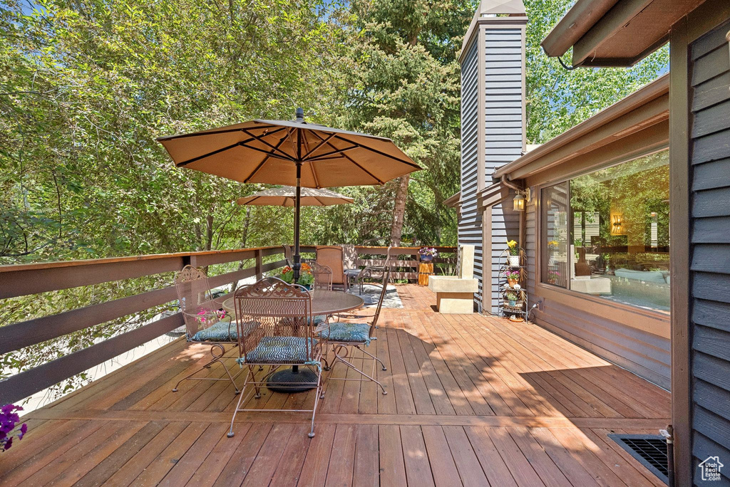 Wooden deck featuring outdoor dining area