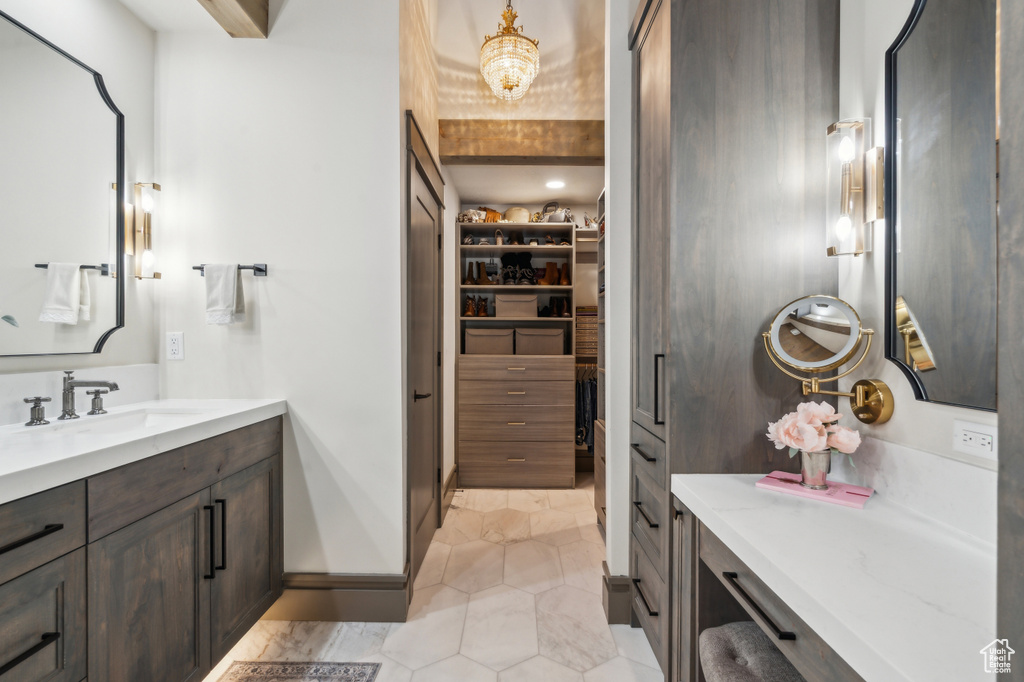 Full bathroom featuring vanity, a spacious closet, and tile patterned flooring