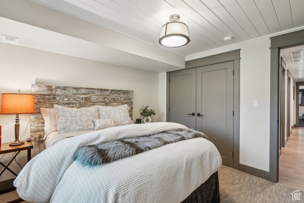 Bedroom featuring a closet, light wood finished floors, and baseboards