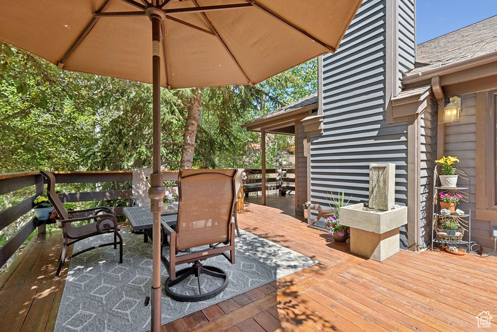 Wooden deck featuring outdoor dining space