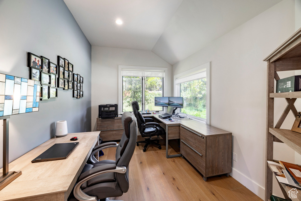 Home office featuring light wood finished floors and lofted ceiling