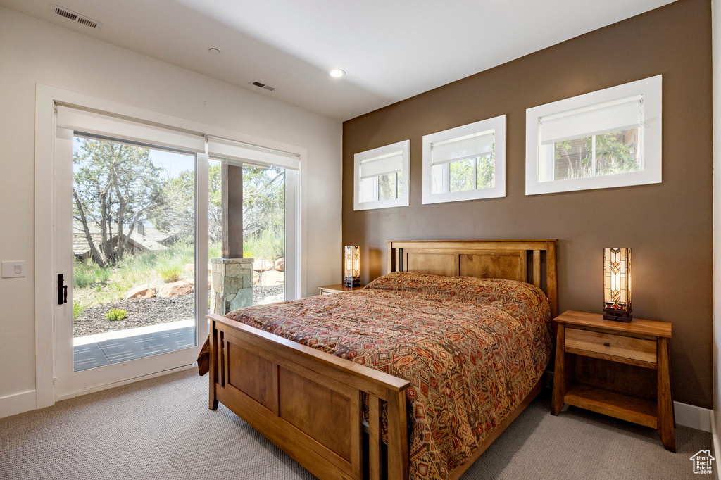 Bedroom with access to outside, light colored carpet, baseboards, and recessed lighting