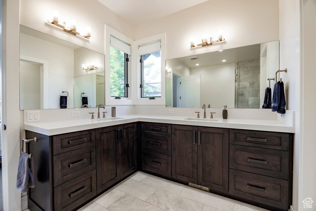 Full bathroom with double vanity and tile patterned floors