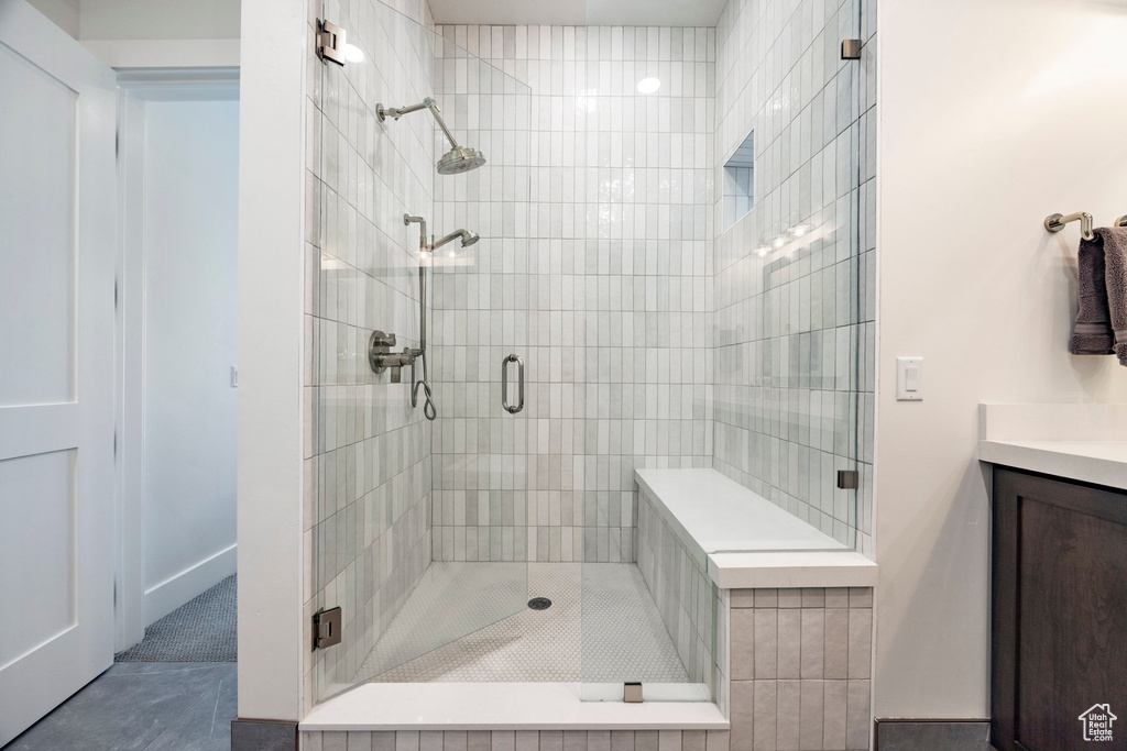 Bathroom featuring a shower stall and vanity