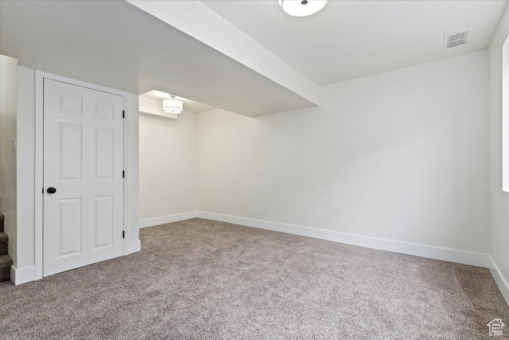 Finished basement featuring carpet floors and baseboards