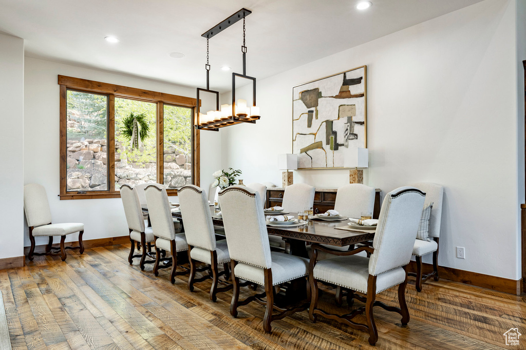 Dining area featuring wood finished floors, baseboards, and recessed lighting